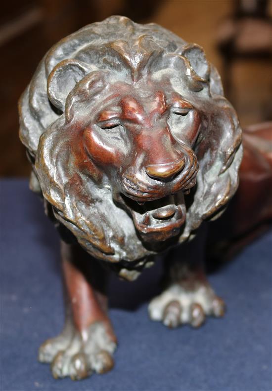 A Japanese brown patinated bronze figure of a roaring lion, Meiji period, length 34cm